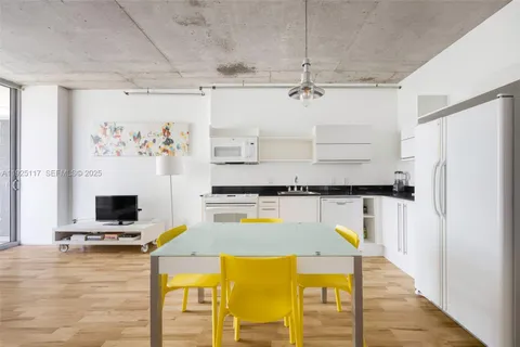 a kitchen with a refrigerator and a stove top oven