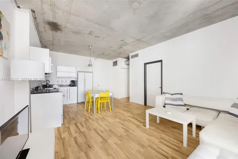 a living room with stainless steel appliances kitchen island granite countertop furniture and a kitchen view