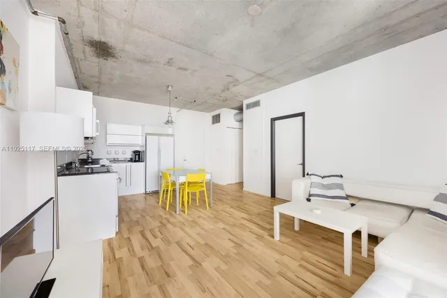 a living room with stainless steel appliances kitchen island granite countertop furniture and a kitchen view