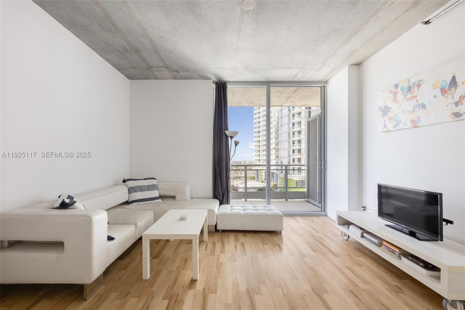 690 Southwest 1st Court, Unit 1830 Miami, FL 33130 - Photo 8 of 15 a living room with furniture and a flat screen tv