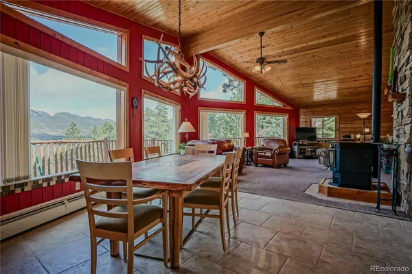 a dining room with furniture a chandelier and a rug