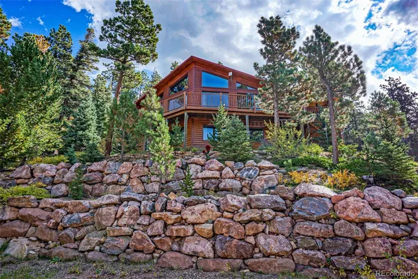a view of a house with a yard and many windows