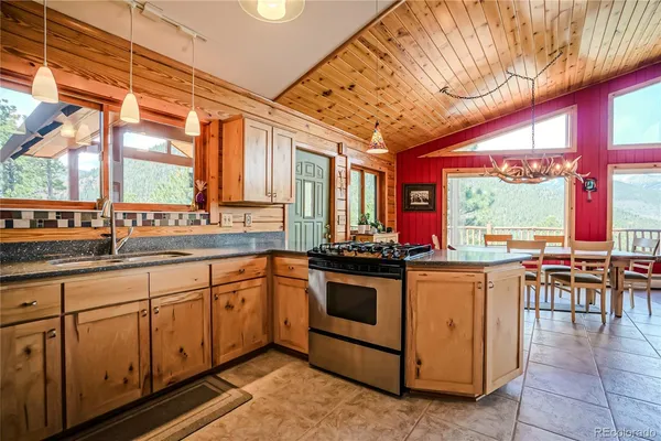 a kitchen with stainless steel appliances granite countertop a stove and cabinets