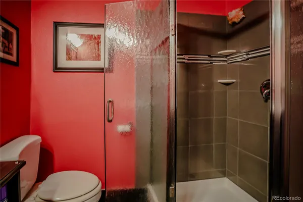 a bathroom with a toilet and a shower
