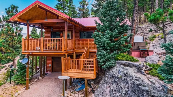 a view of a house with a yard and furniture