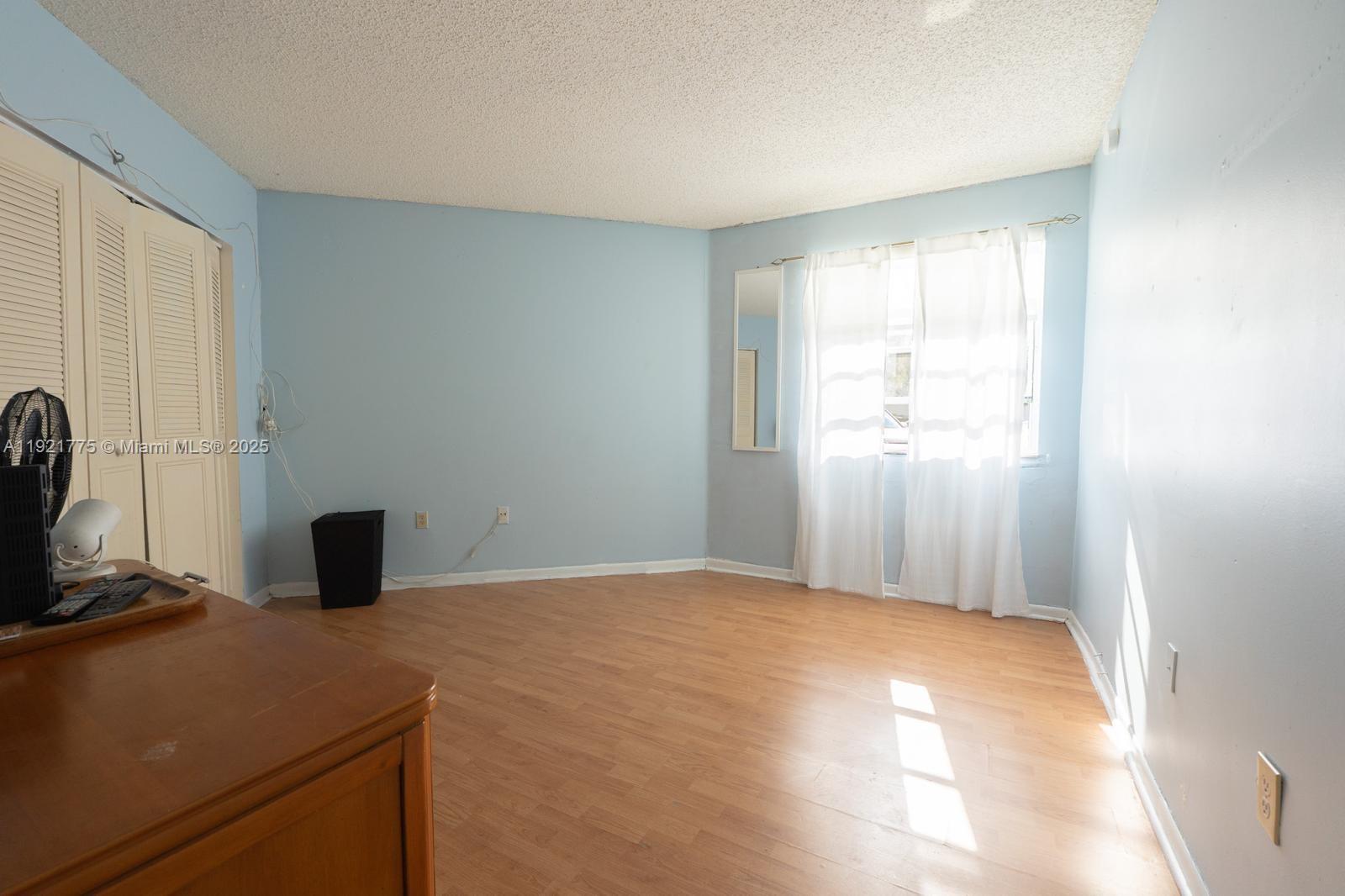 6276 Northwest 186th Street, Unit 112 Hialeah, FL 33015 - Photo 11 of 22 a bedroom with a bed and a window