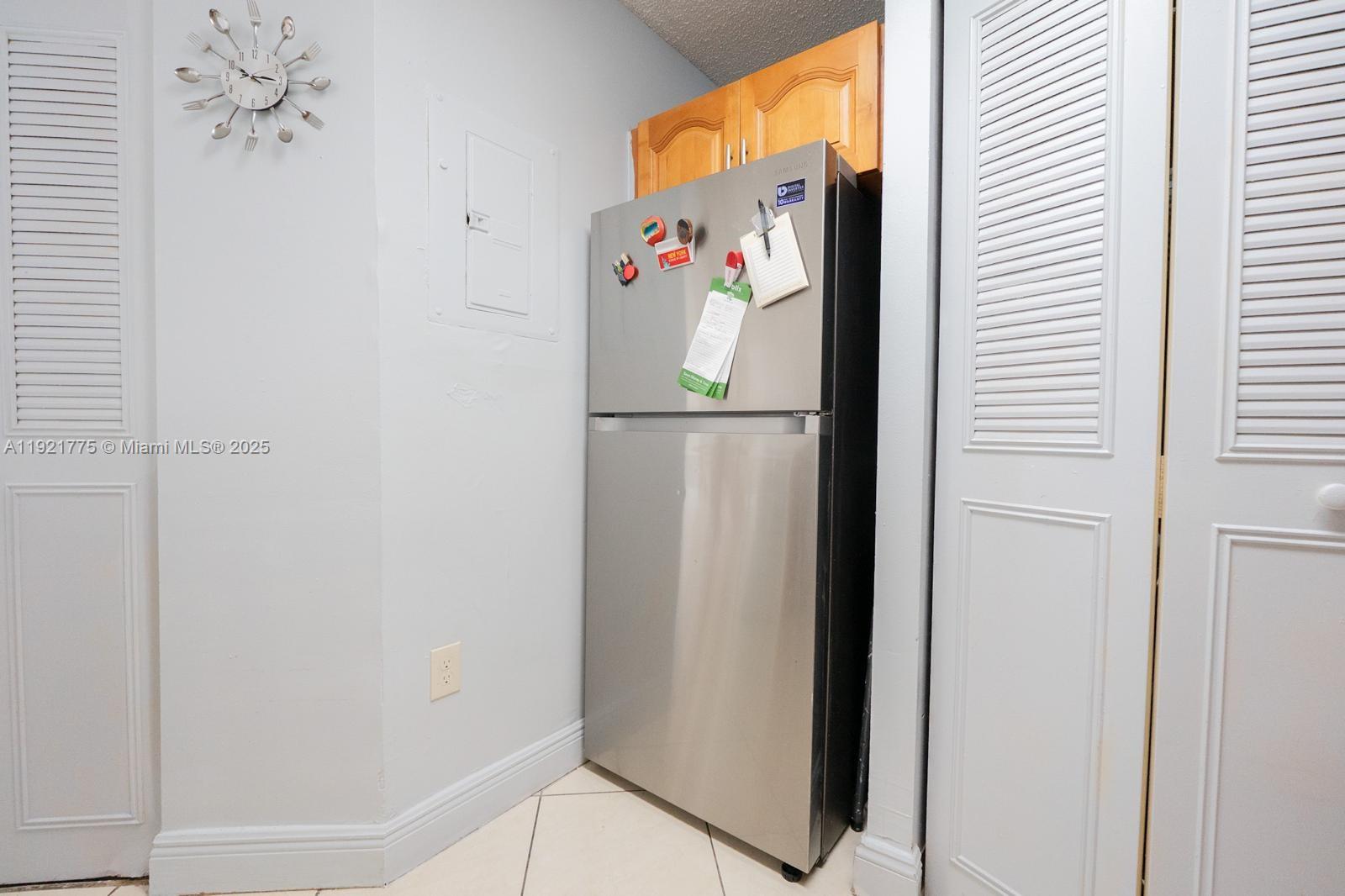 6276 Northwest 186th Street, Unit 112 Hialeah, FL 33015 - Photo 13 of 22 a white refrigerator freezer sitting inside of a kitchen