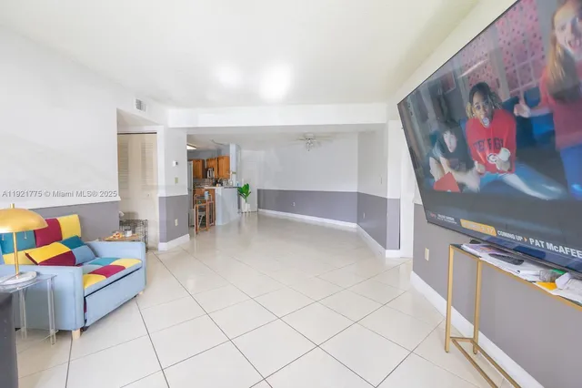 a living room with furniture and painting on the wall