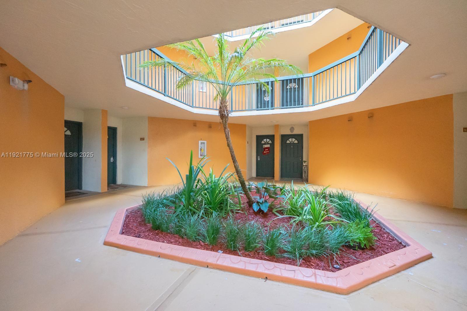 6276 Northwest 186th Street, Unit 112 Hialeah, FL 33015 - Photo 4 of 22 a front view of a house with garden