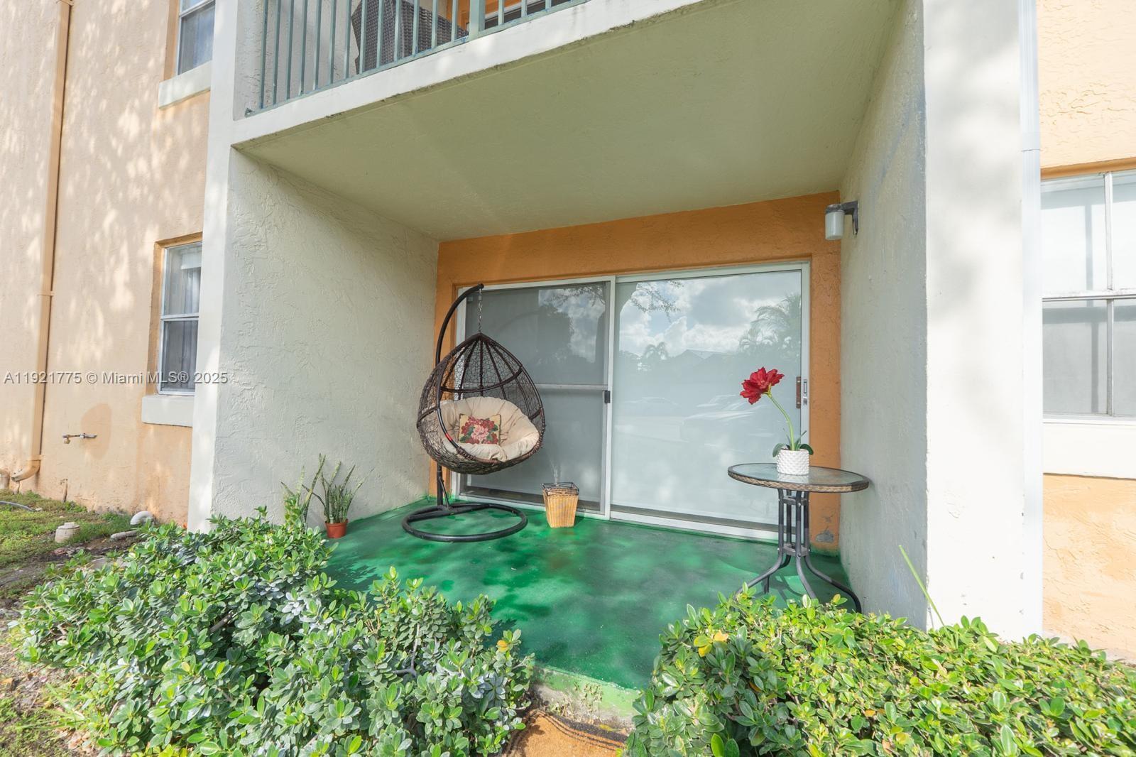 6276 Northwest 186th Street, Unit 112 Hialeah, FL 33015 - Photo 5 of 22 a front view of a house with garden
