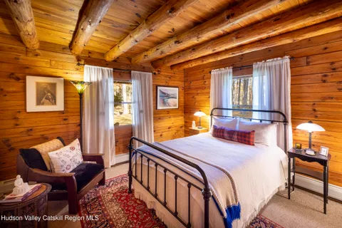 a bedroom with furniture and a window