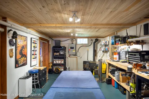 a view of a yard with plants and a bench