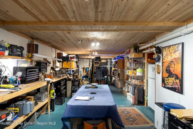 a view of a patio with dining table and chairs and potted plants