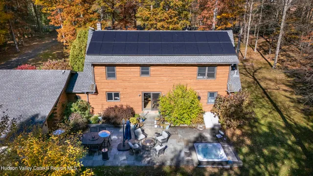 a front view of a house with a yard table and chairs