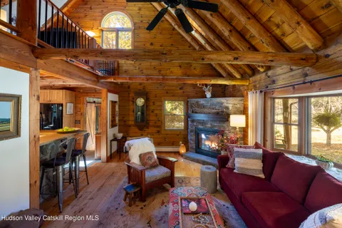 a living room with furniture a fireplace and a chandelier