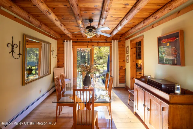 a view of a room with furniture large windows and wooden floor