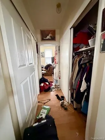 a view of walk in closet with clothes and shoes