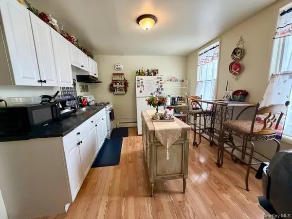 a bathroom with a sink mirror vanity and toilet