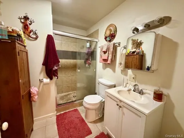 a bedroom with two beds and a dresser with wooden floor