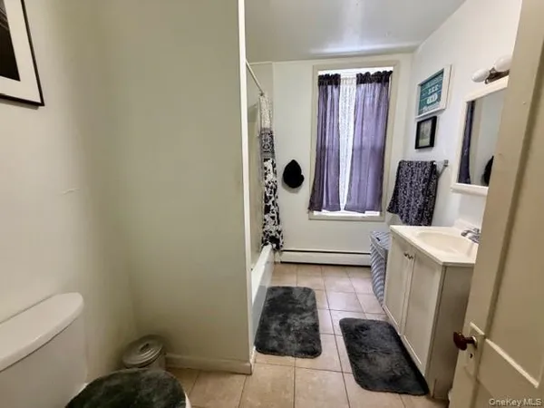 a bedroom with bed and a window