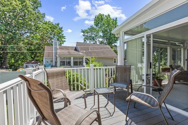 a view of a chair and tables in the balcony