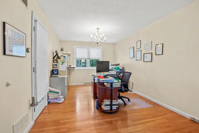 a work room with furniture and wooden floor