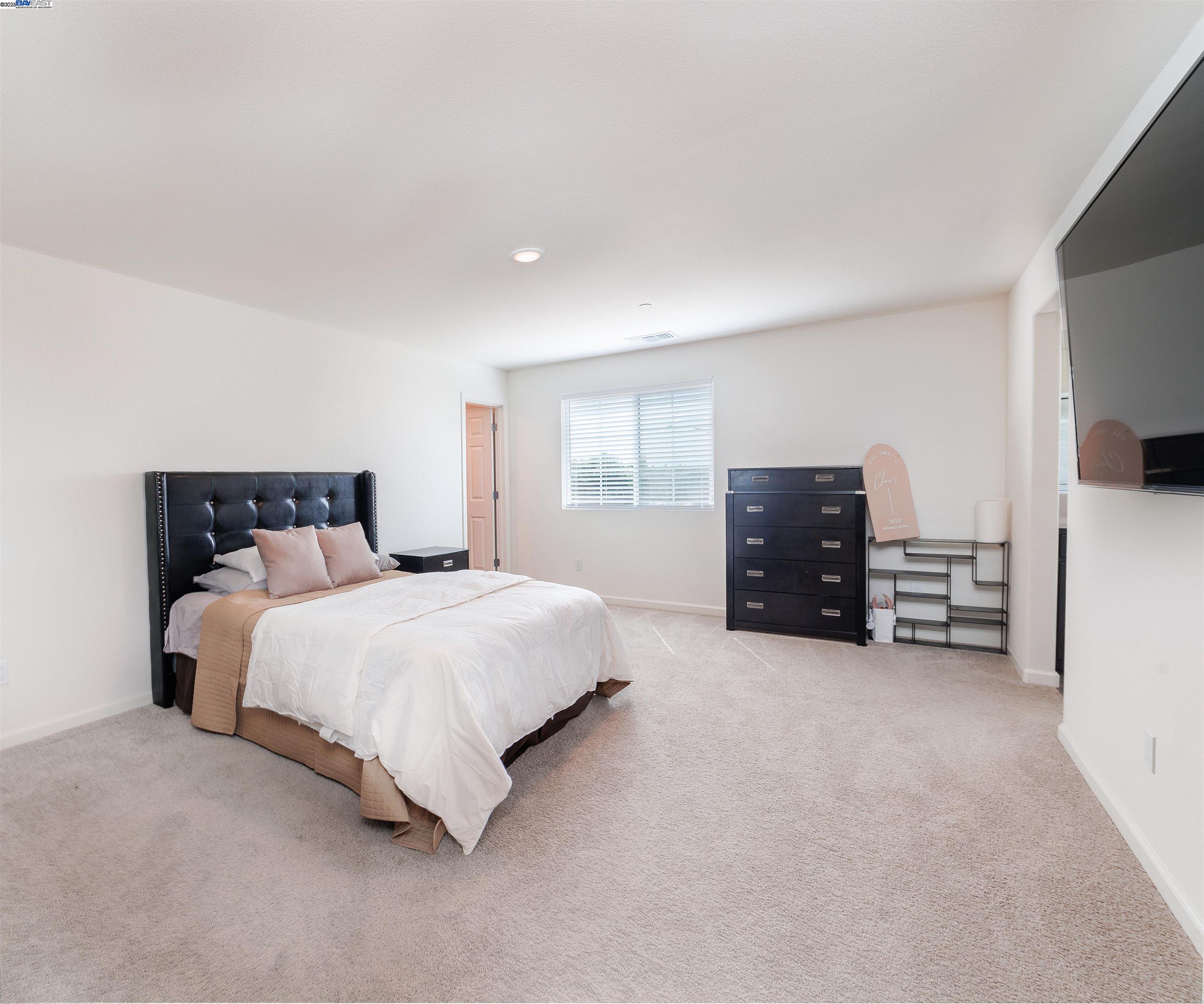 Van Buskirk Stockton, CA 95206 - Photo 11 of 14 a spacious bedroom with a bed and dresser