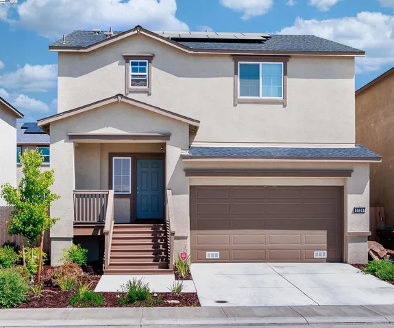 a front view of a house with a garage