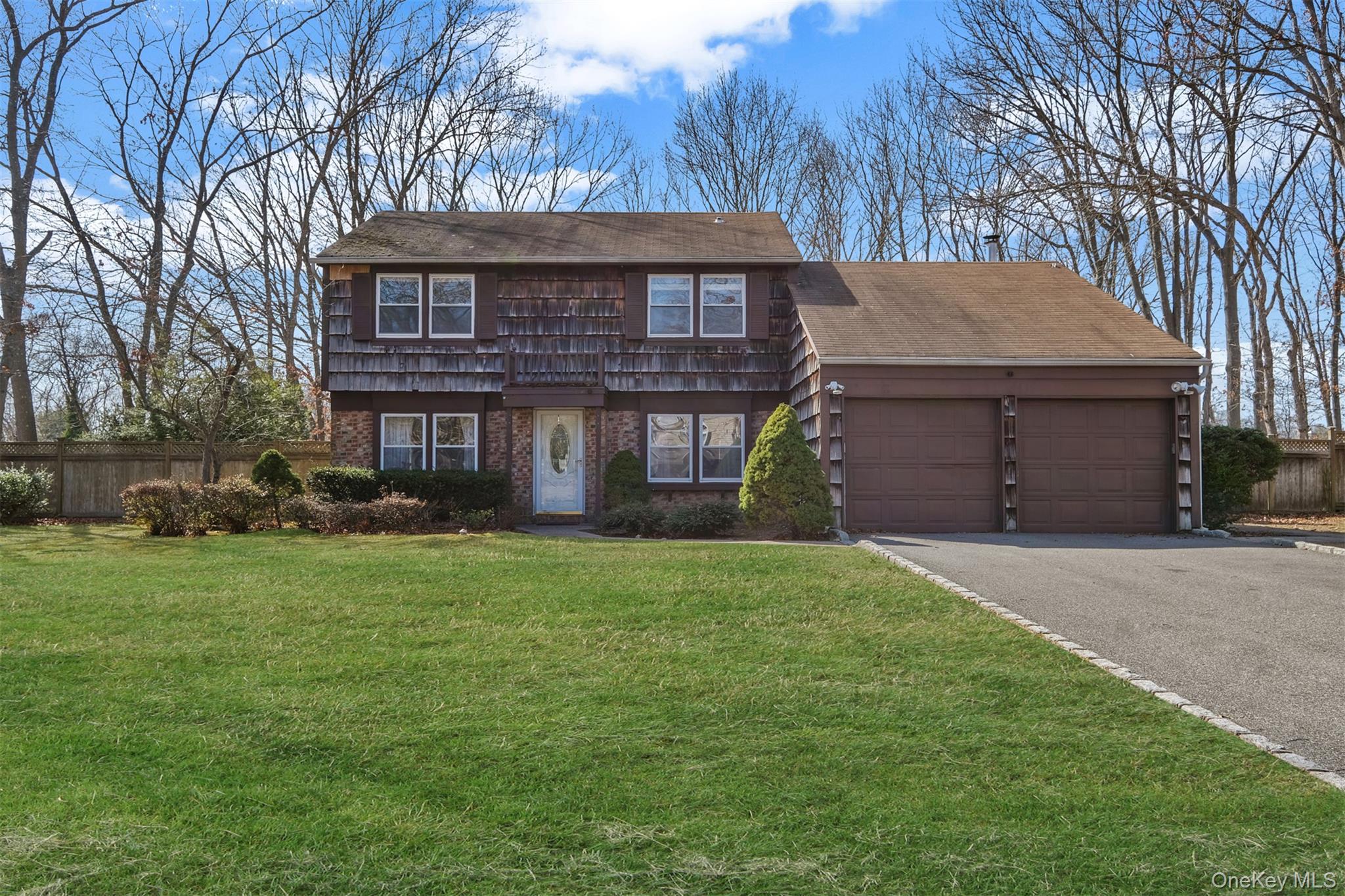 2 Biscayne Drive Mount Sinai, NY 11766 - Photo 1 of 1 a front view of a house with a garden