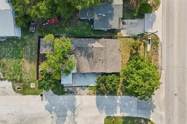 an aerial view of a house with a yard and garden