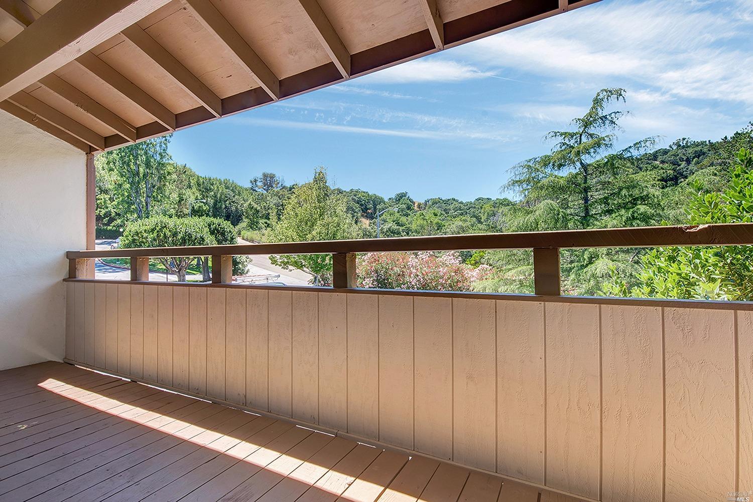 a view of outdoor space with wooden floor