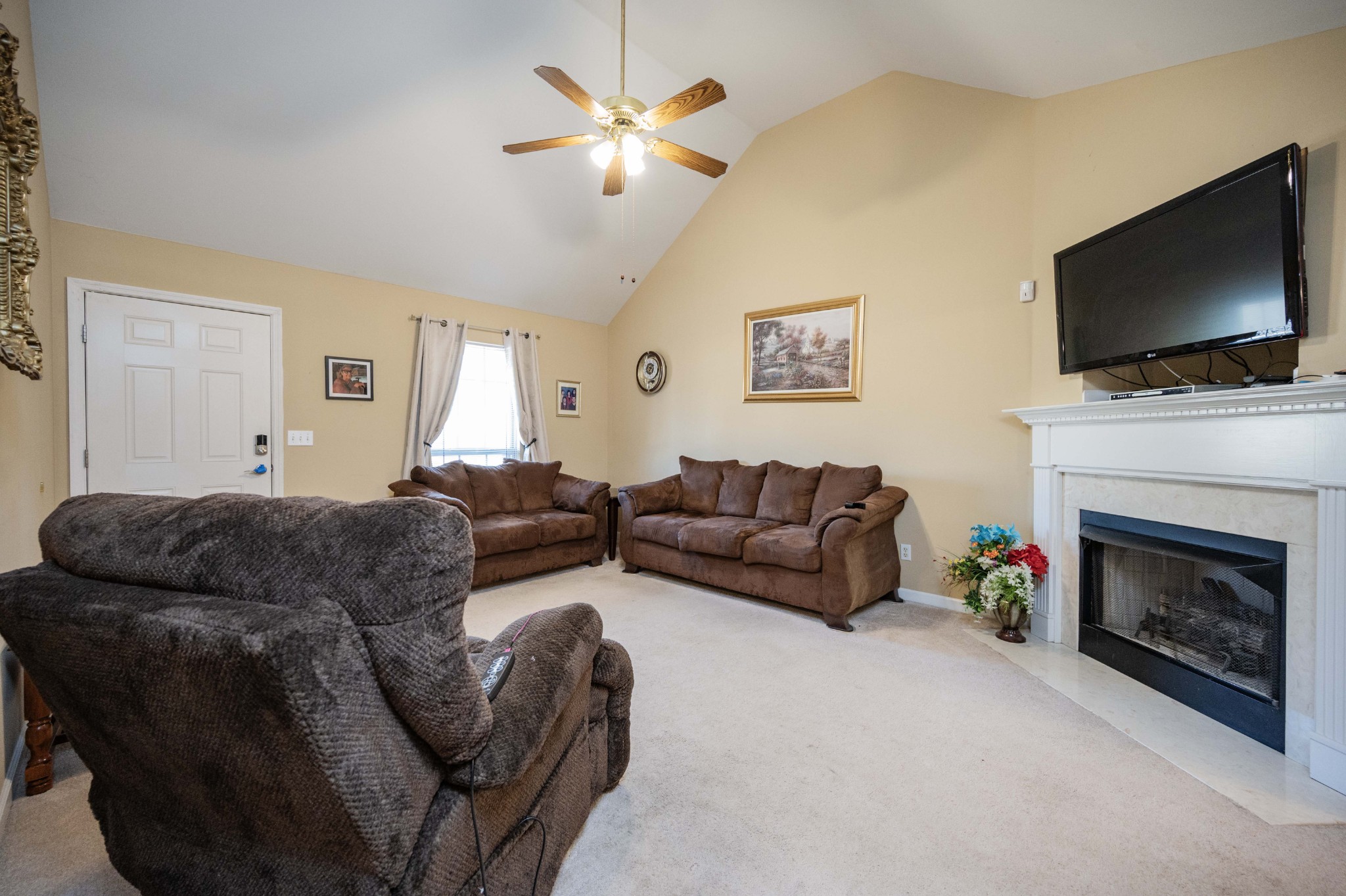 412 Conhocken Court Murfreesboro, TN 37128 - Photo 5 of 23 a living room with furniture a flat screen tv and a fireplace