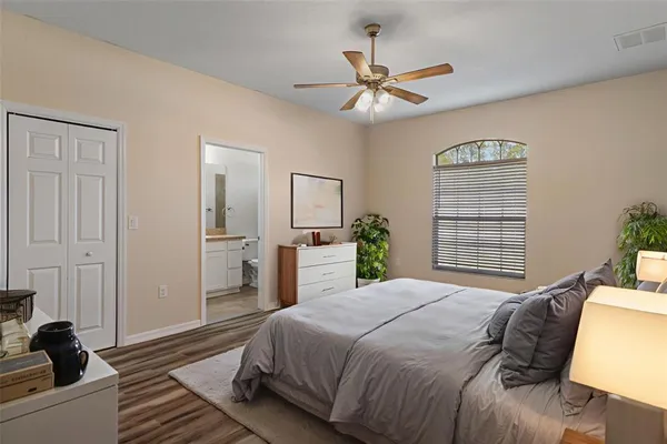 a bedroom with a bed and a chandelier