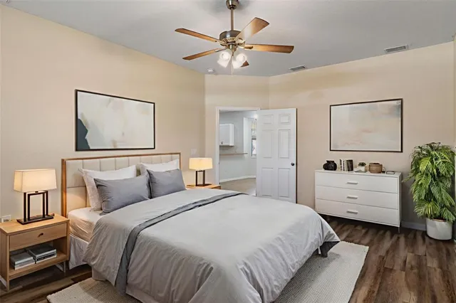 a bedroom with a white bed and a chandelier