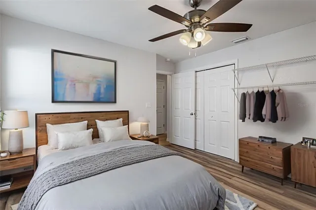 a bedroom with a bed and a chandelier