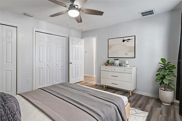 a bedroom with a bed and a potted plant