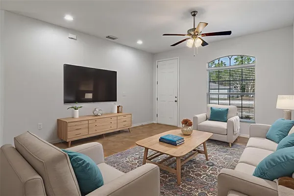 a living room with furniture and a flat screen tv