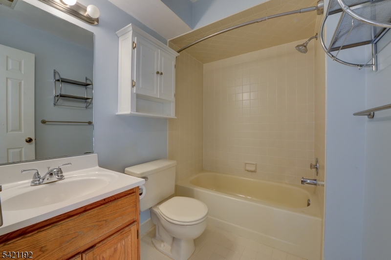 220 Alexandria Way Bernards, NJ 07920 - Photo 14 of 18 a bathroom with a granite countertop sink a toilet and shower