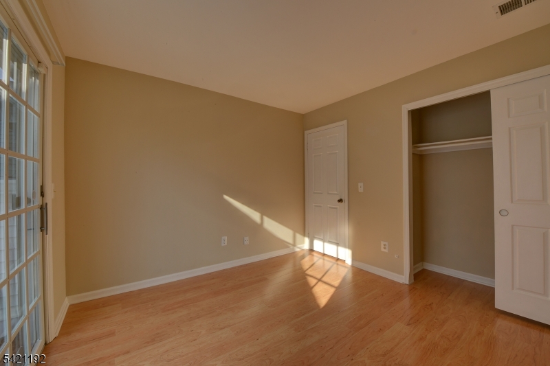 220 Alexandria Way Bernards, NJ 07920 - Photo 16 of 18 an empty room with wooden floor and windows