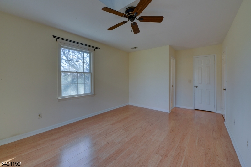 220 Alexandria Way Bernards, NJ 07920 - Photo 4 of 18 wooden floor in an empty room with a window