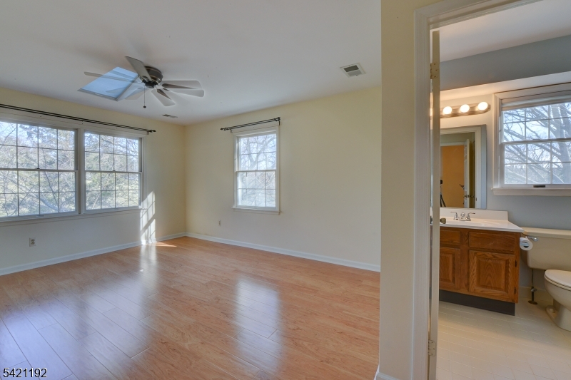220 Alexandria Way Bernards, NJ 07920 - Photo 5 of 18 a view of an empty room with a window and wooden floor