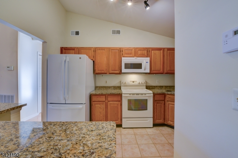 220 Alexandria Way Bernards, NJ 07920 - Photo 8 of 18 a kitchen with stainless steel appliances granite countertop a refrigerator sink and stove