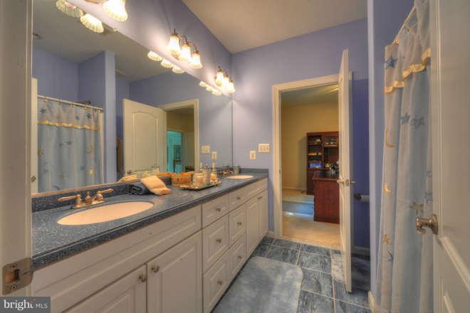 1721 Tacoma Road Edgewater, MD 21037 - Photo 22 of 30 a spacious bathroom with a double vanity sink a mirror and a shower