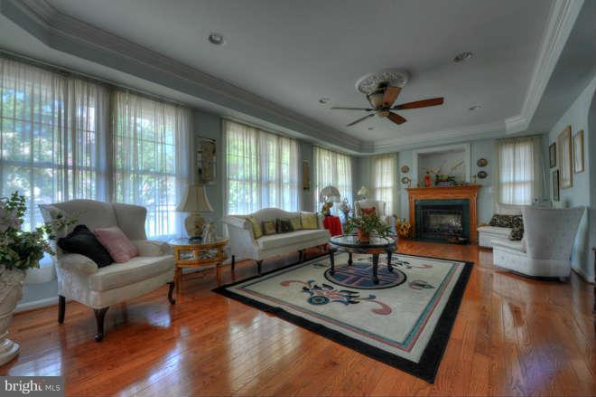 1721 Tacoma Road Edgewater, MD 21037 - Photo 7 of 30 a living room with furniture a fireplace and a large window