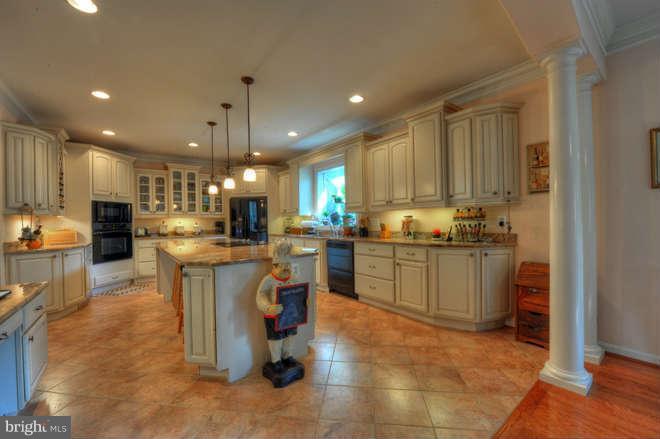 1721 Tacoma Road Edgewater, MD 21037 - Photo 9 of 30 a kitchen with a refrigerator a counter top space appliances and a cabinets