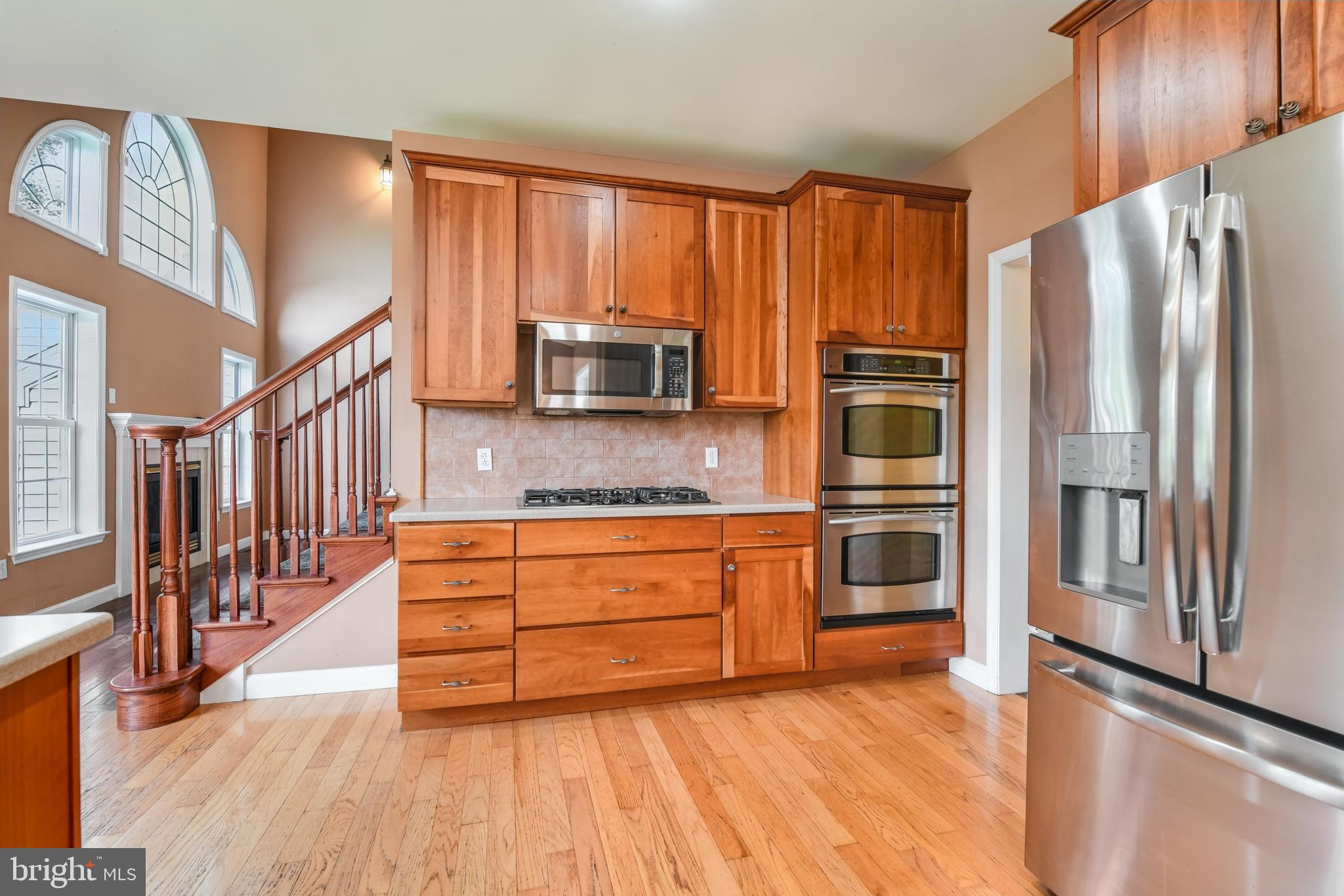 2 Forest Road Mohnton, PA 19540 - Photo 21 of 54 a kitchen with stainless steel appliances granite countertop a refrigerator a stove a sink and dishwasher with wooden floor