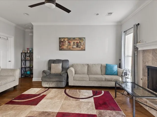 a living room with furniture a rug and a fireplace