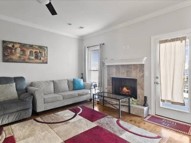a living room with furniture a rug and a fireplace