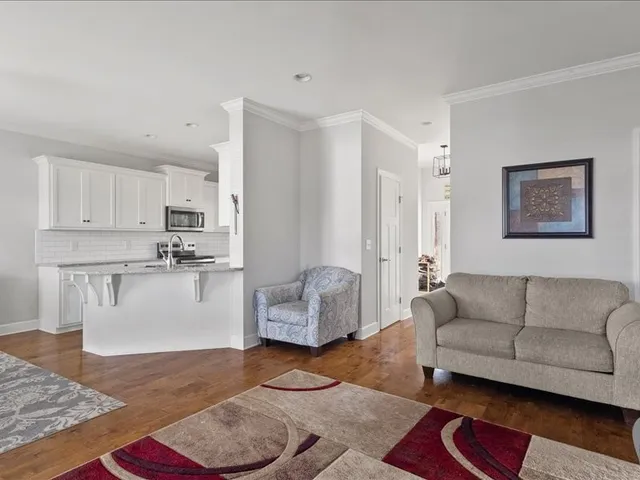 a living room with furniture and a rug
