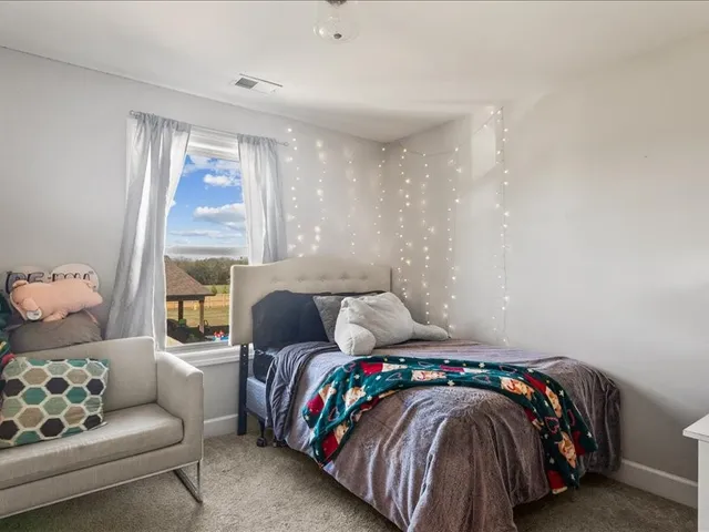 a bedroom with a bed and window